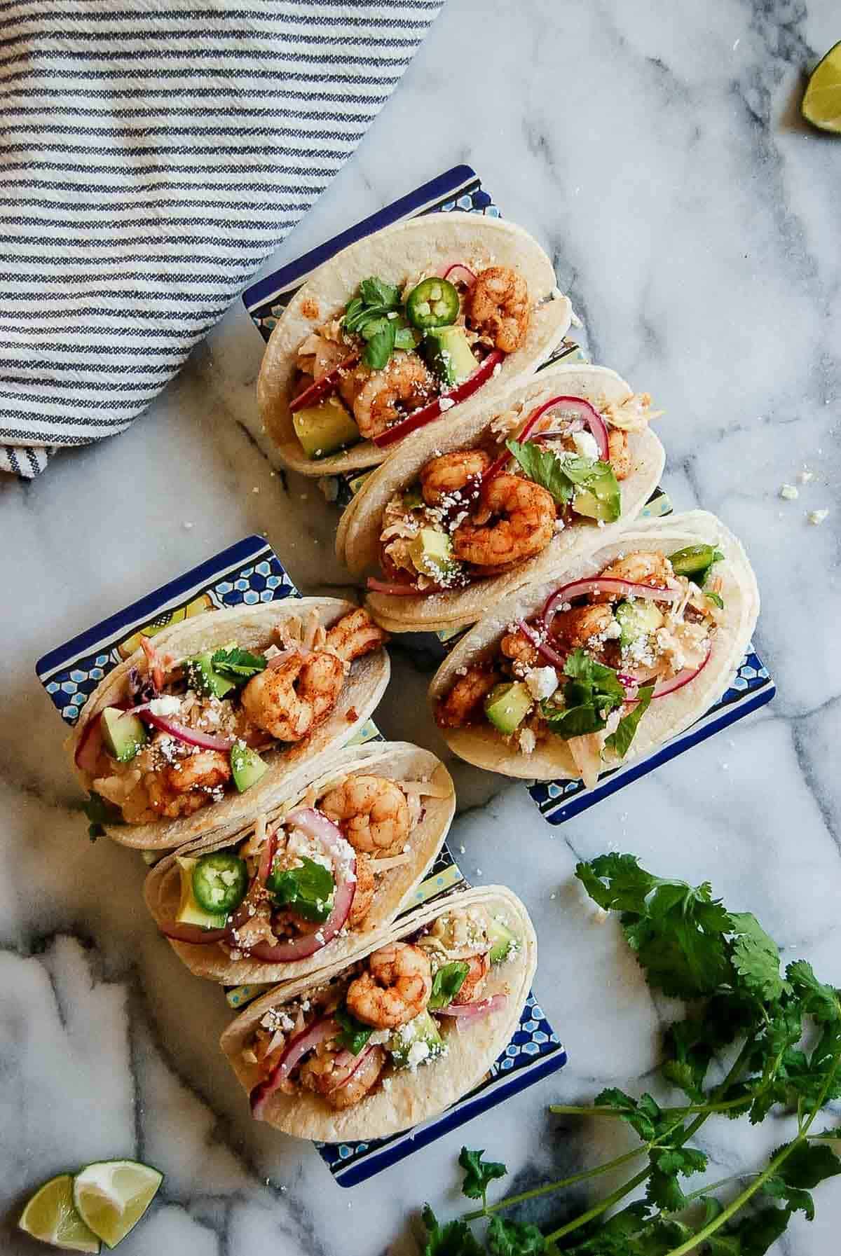 trays of shrimp tacos on countertop.