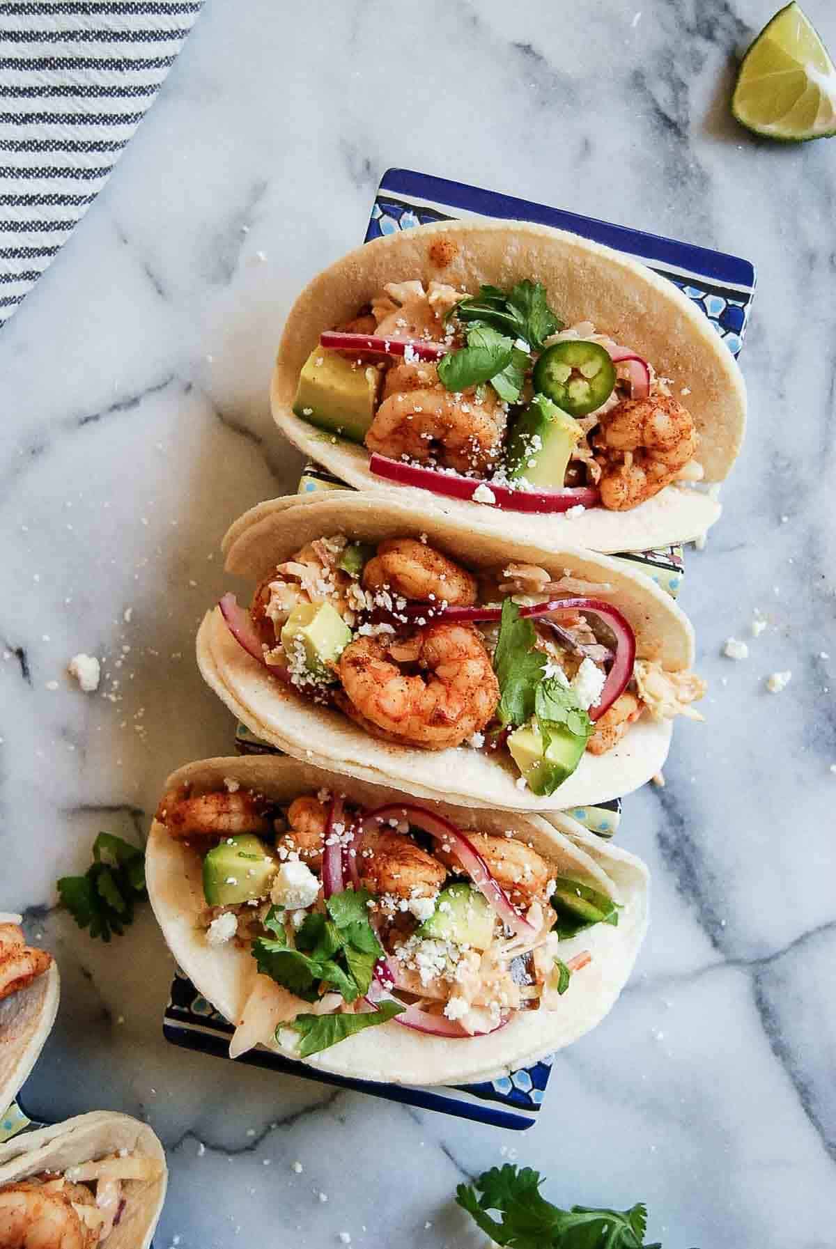 baja shrimp tacos in tray on countertop.