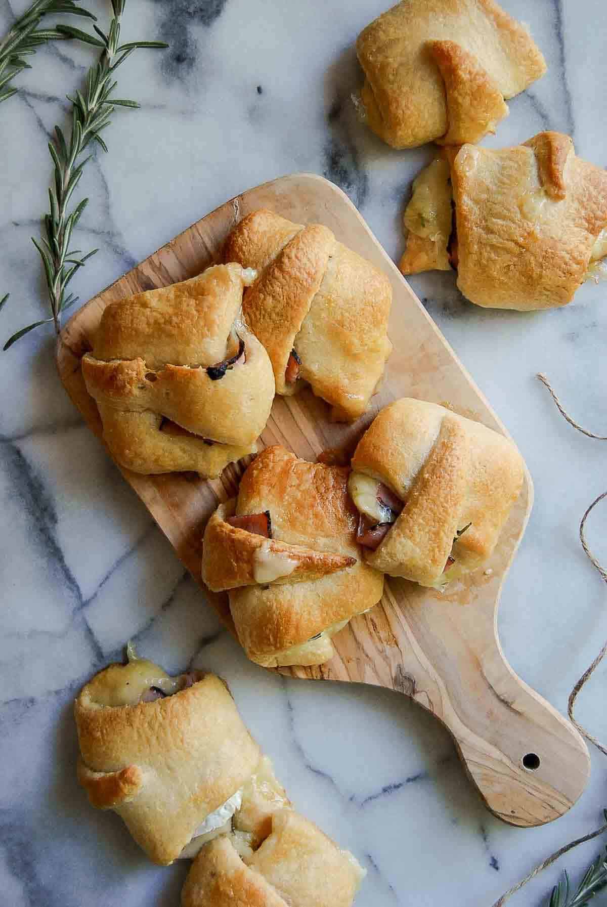 ham and cheese crescent rolls on cutting board.