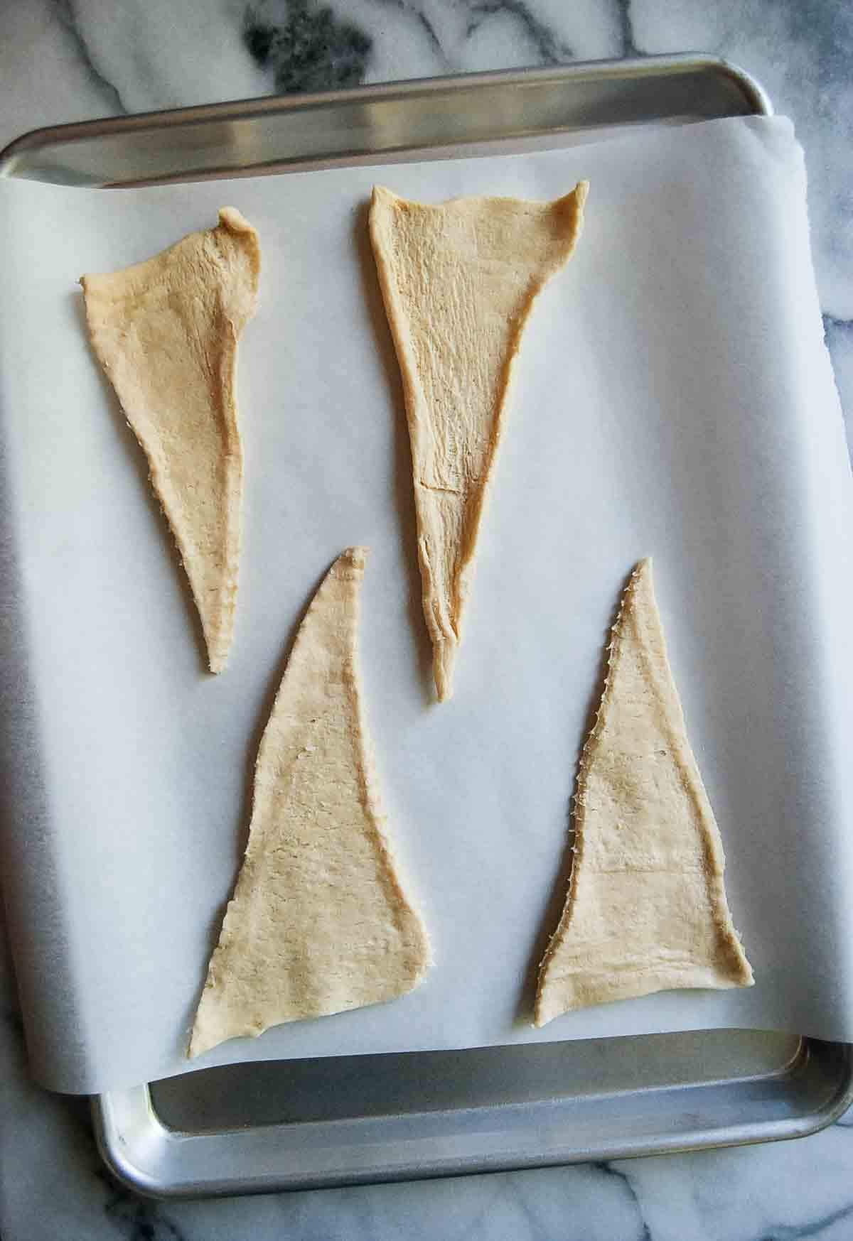 rolled out crescent rolls on baking tray.