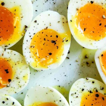 closeup of jammy eggs on plate.
