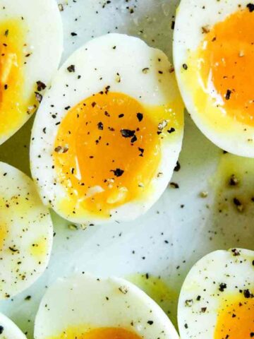closeup of jammy eggs on plate.