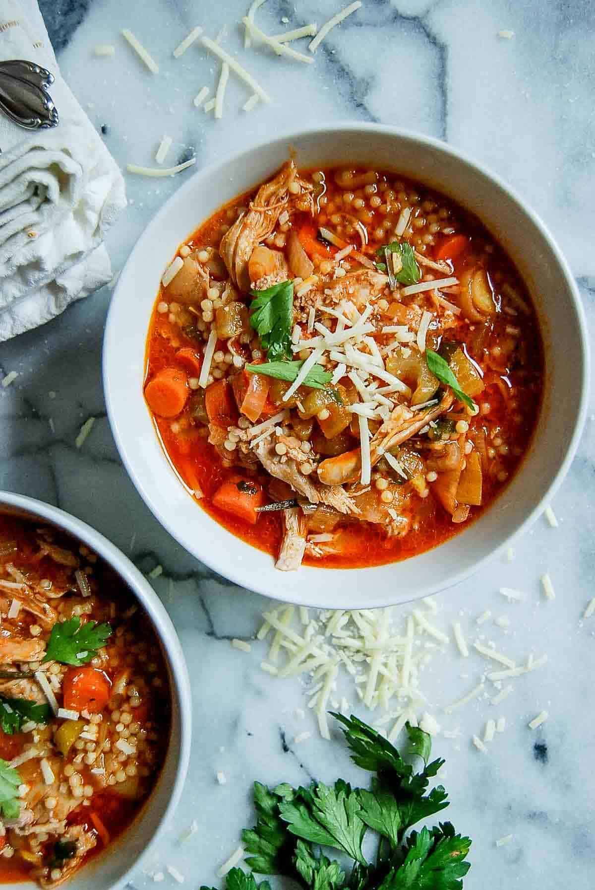bowl of Italian pastina soup on countertop.