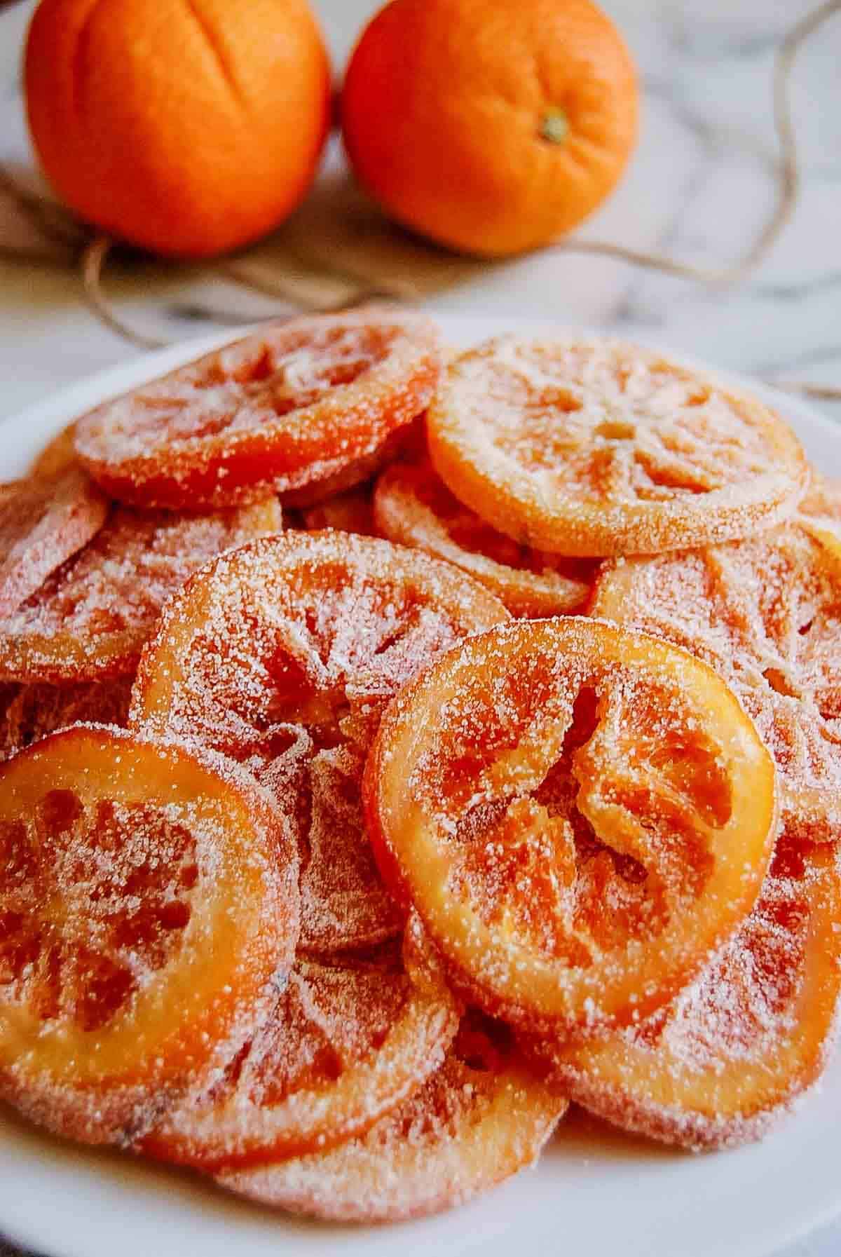 side view of candied orange slices on plate.