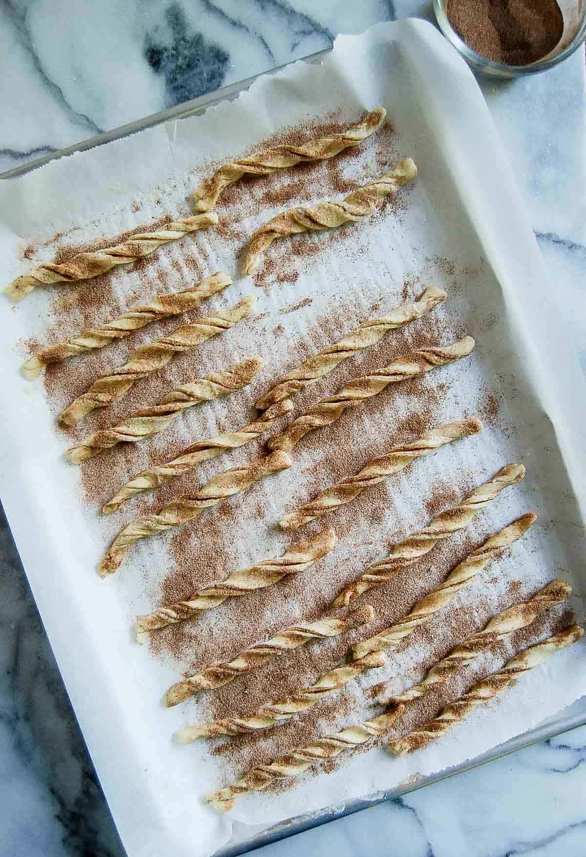 tray of cinnamon twist dough on baking pan.