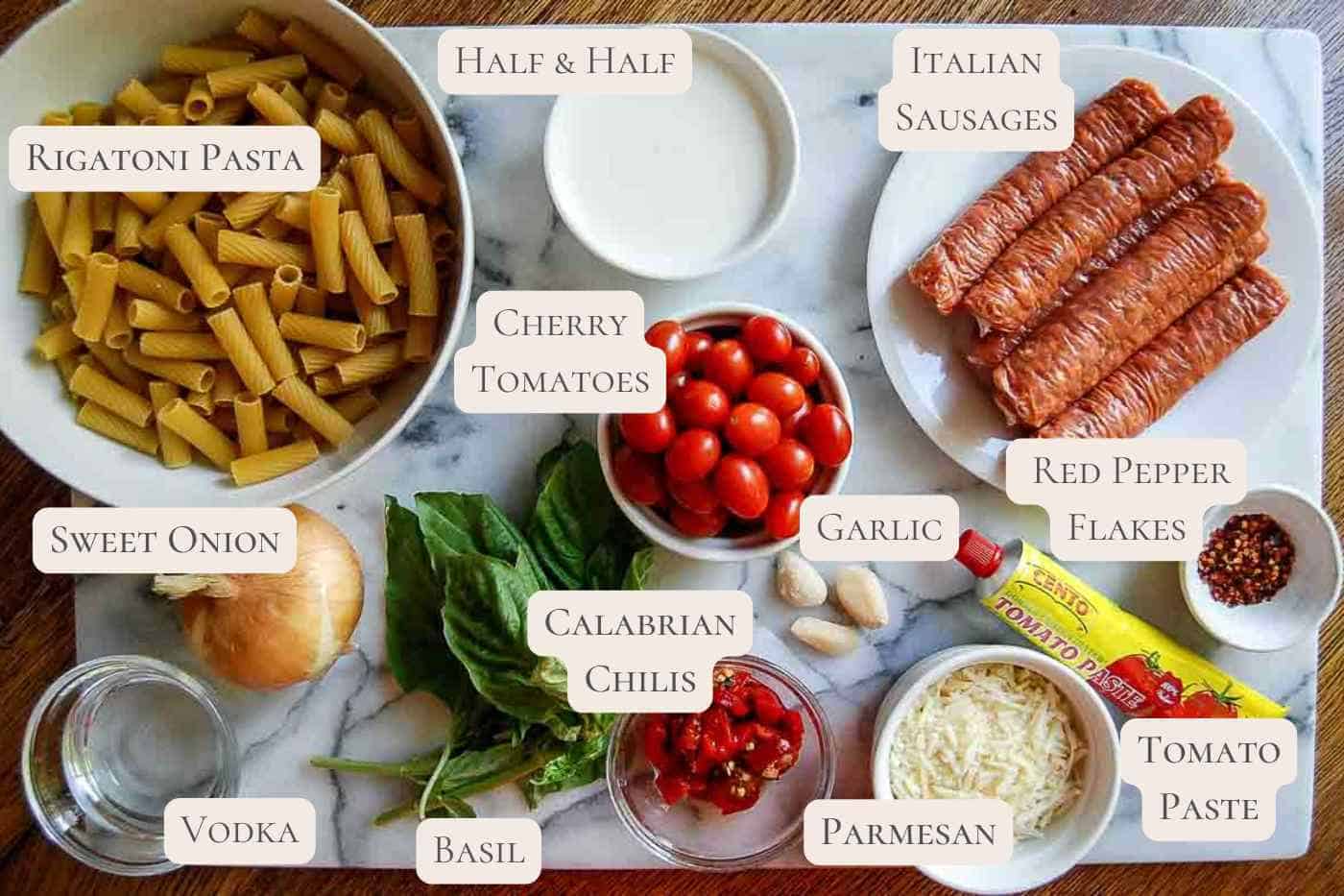 ingredients for spicy rigatoni vodka pasta on countertop, labeled.