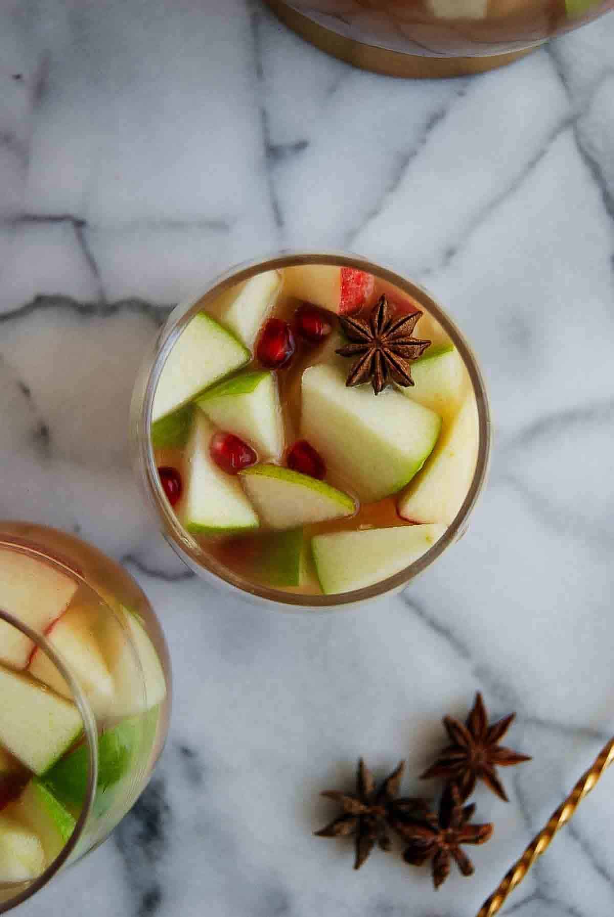 thanksgiving sangria in glass with star anise as a garnish.