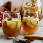 side view of thanksgiving sangria in glasses with cinnamon stick and star anise on the side.