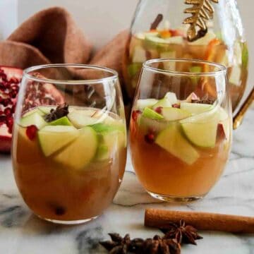 side view of thanksgiving sangria in glasses with cinnamon stick and star anise on the side.