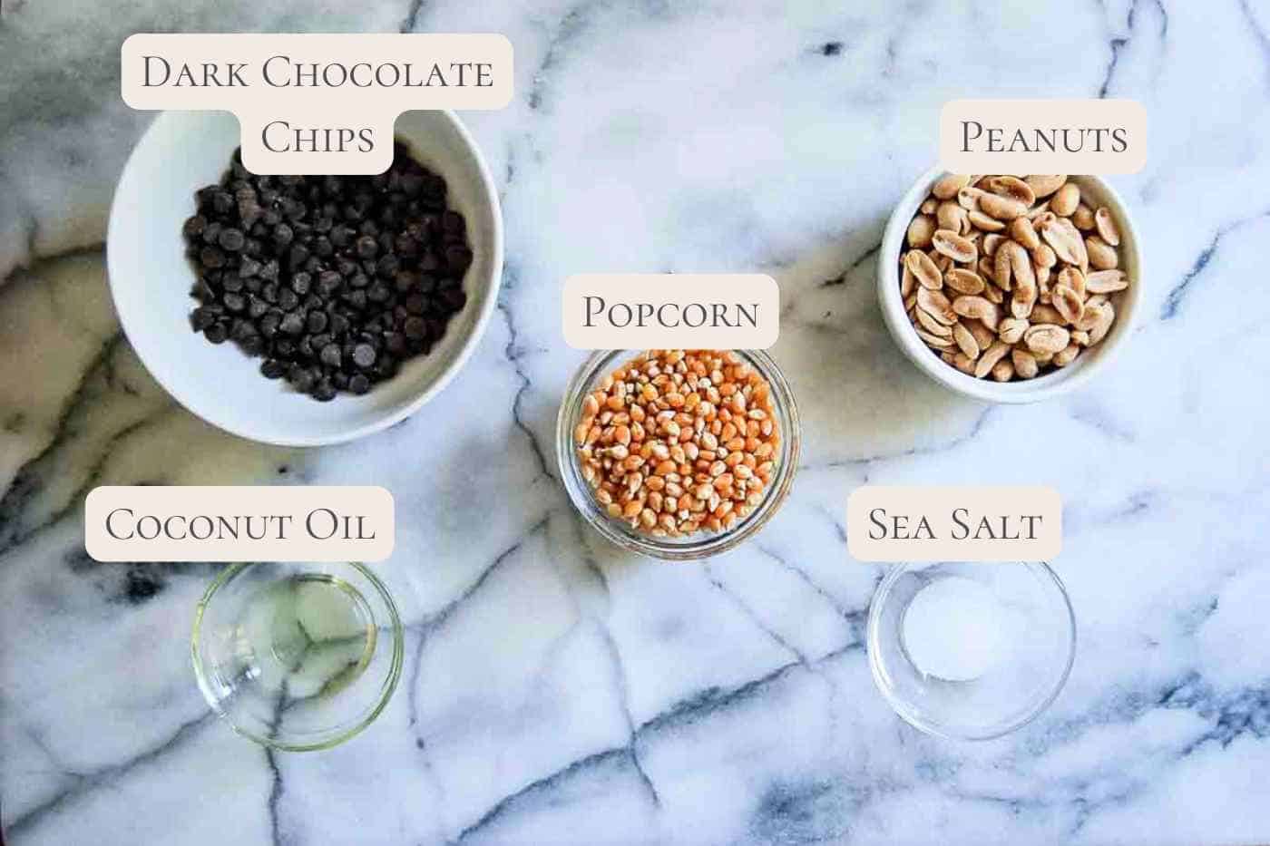 ingredients for chocolate drizzled popcorn on countertop, labeled.