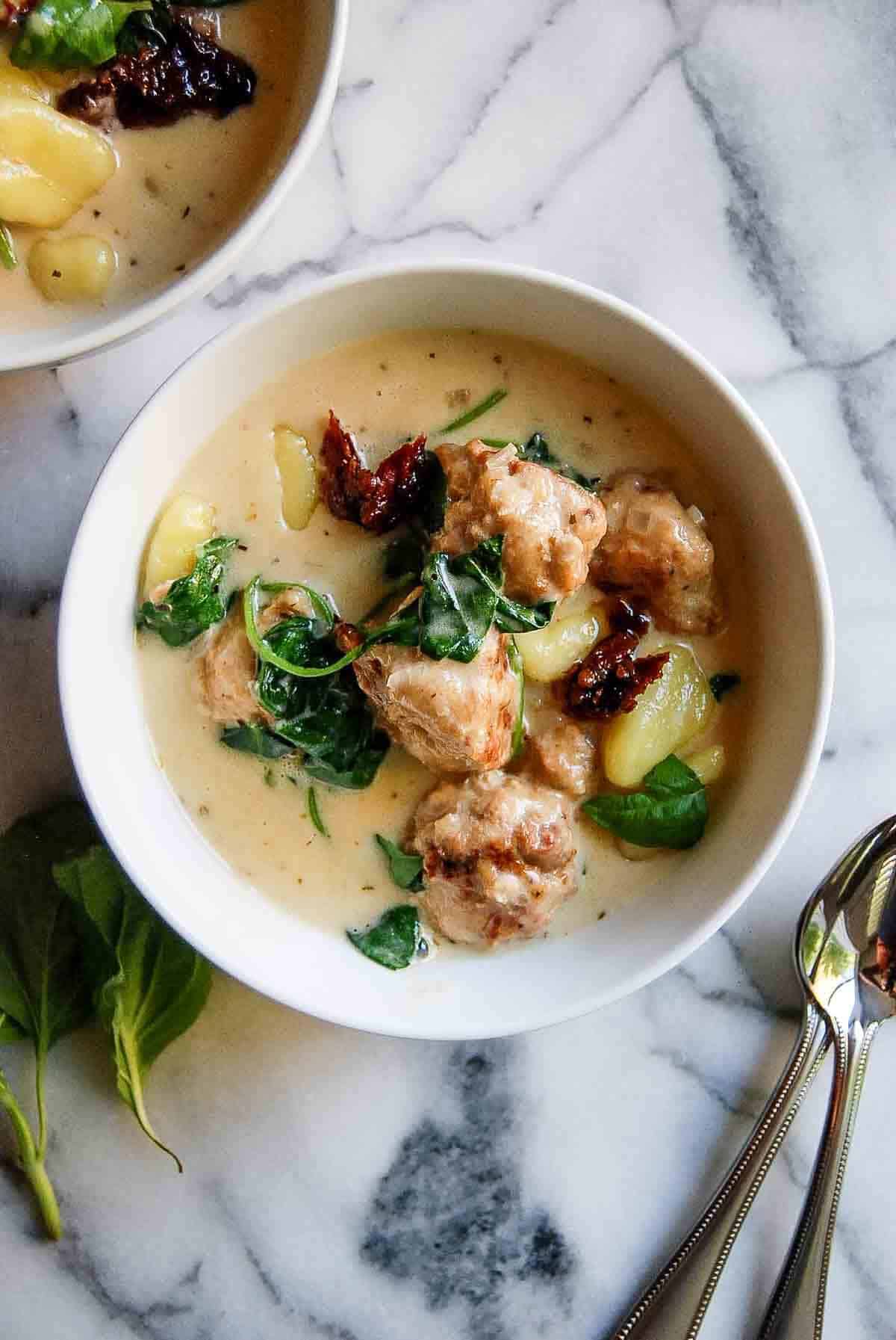 closeup of bowl full of chicken meatballs and gnocchi mixture.