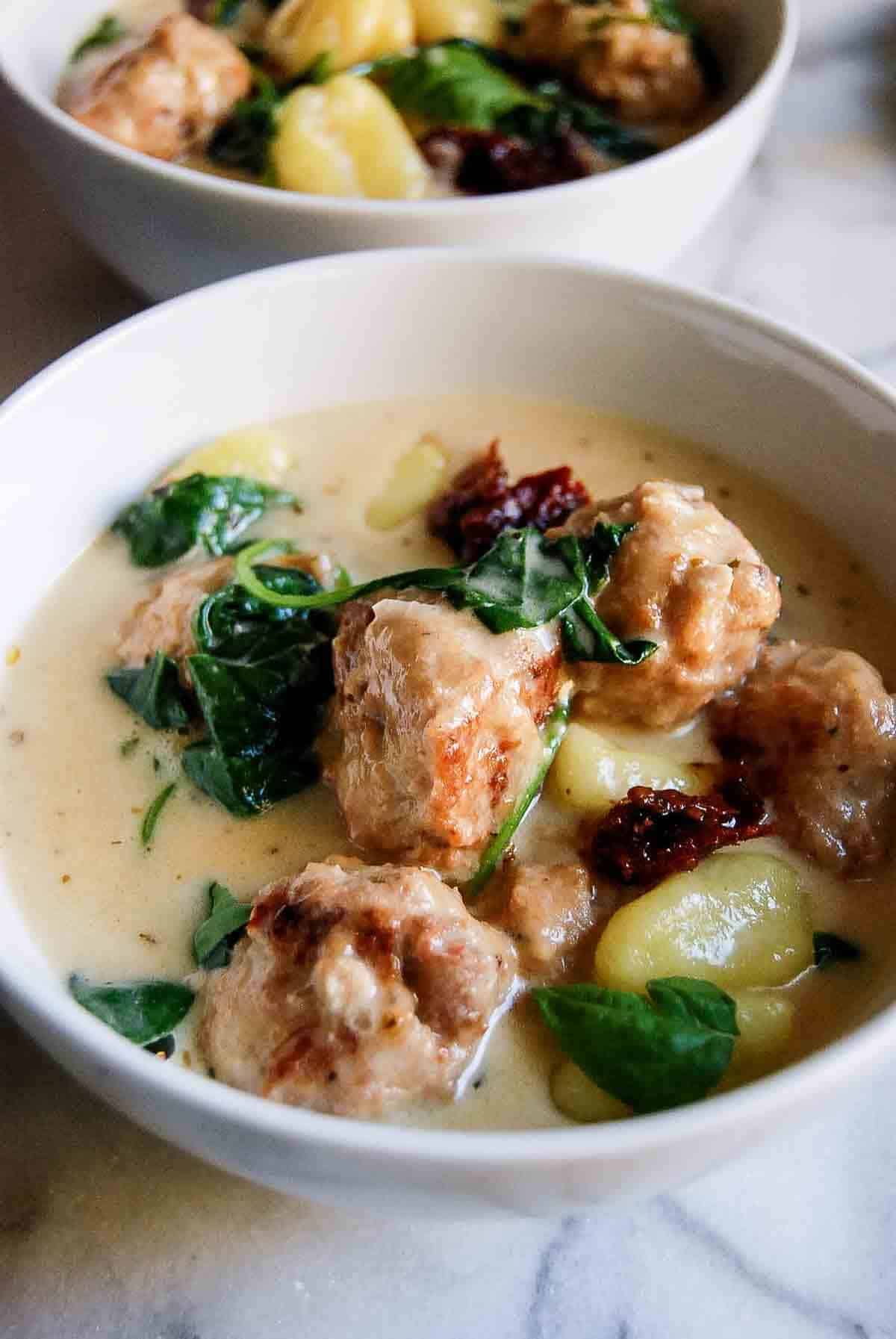 closeup of slow cooker chicken meatballs and gnocchi dish.