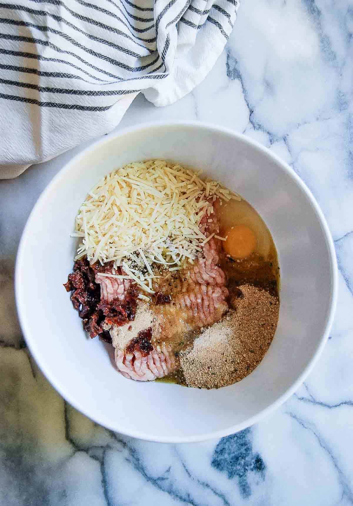 chicken meatball ingredients in mixing bowl.
