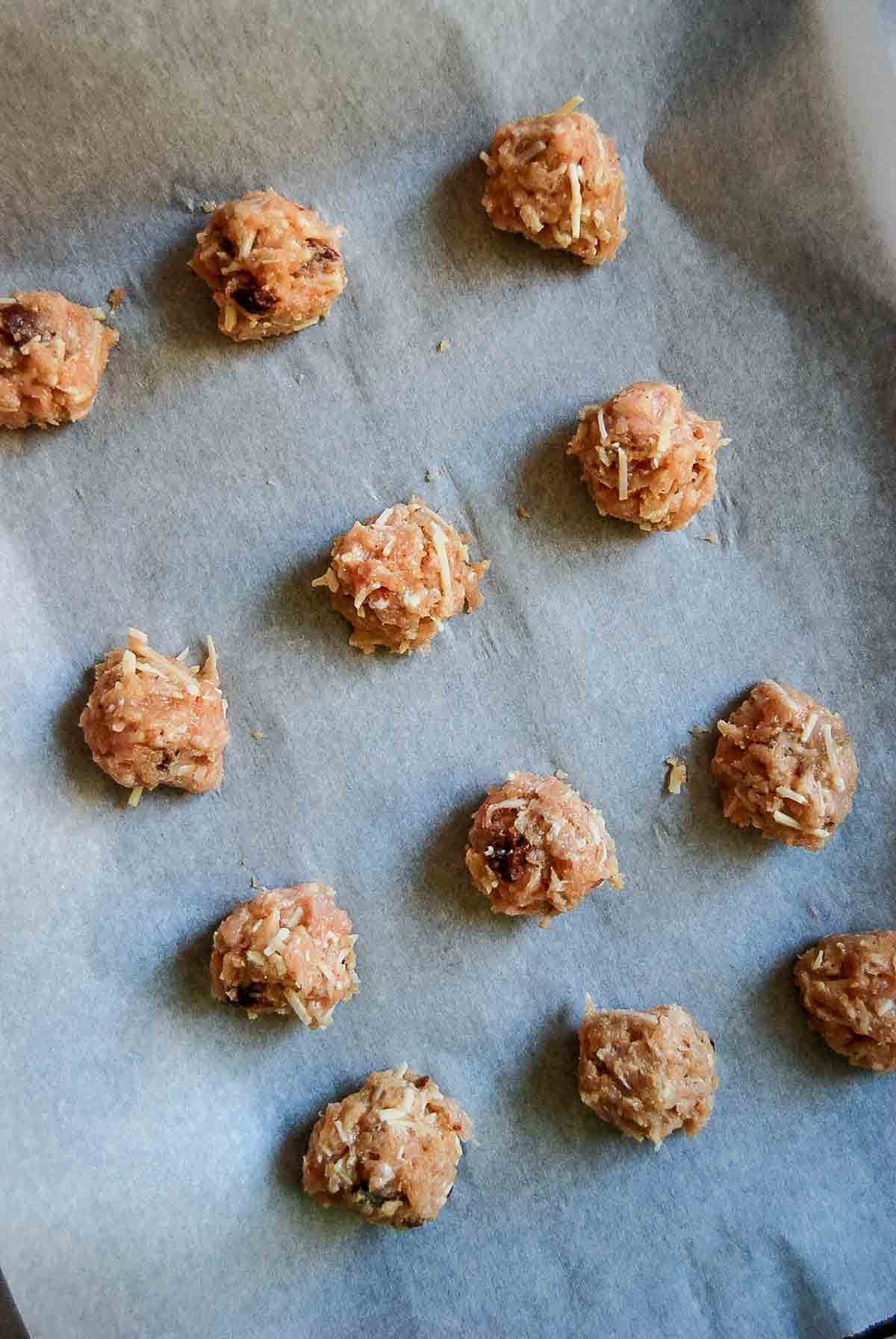 chicken meatballs, formed and on baking tray, ready for baking.