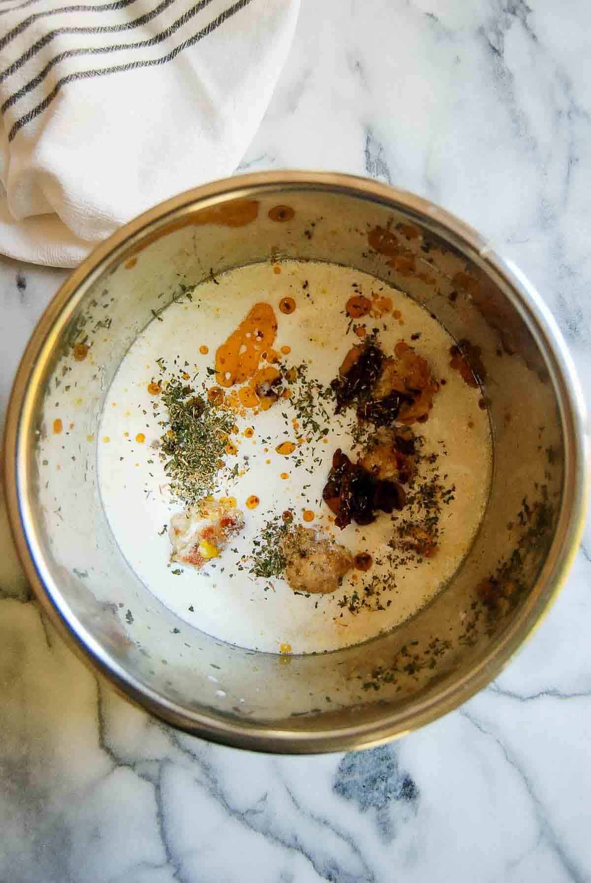 chicken. meatballs and creamy broth in slow cooker pot.