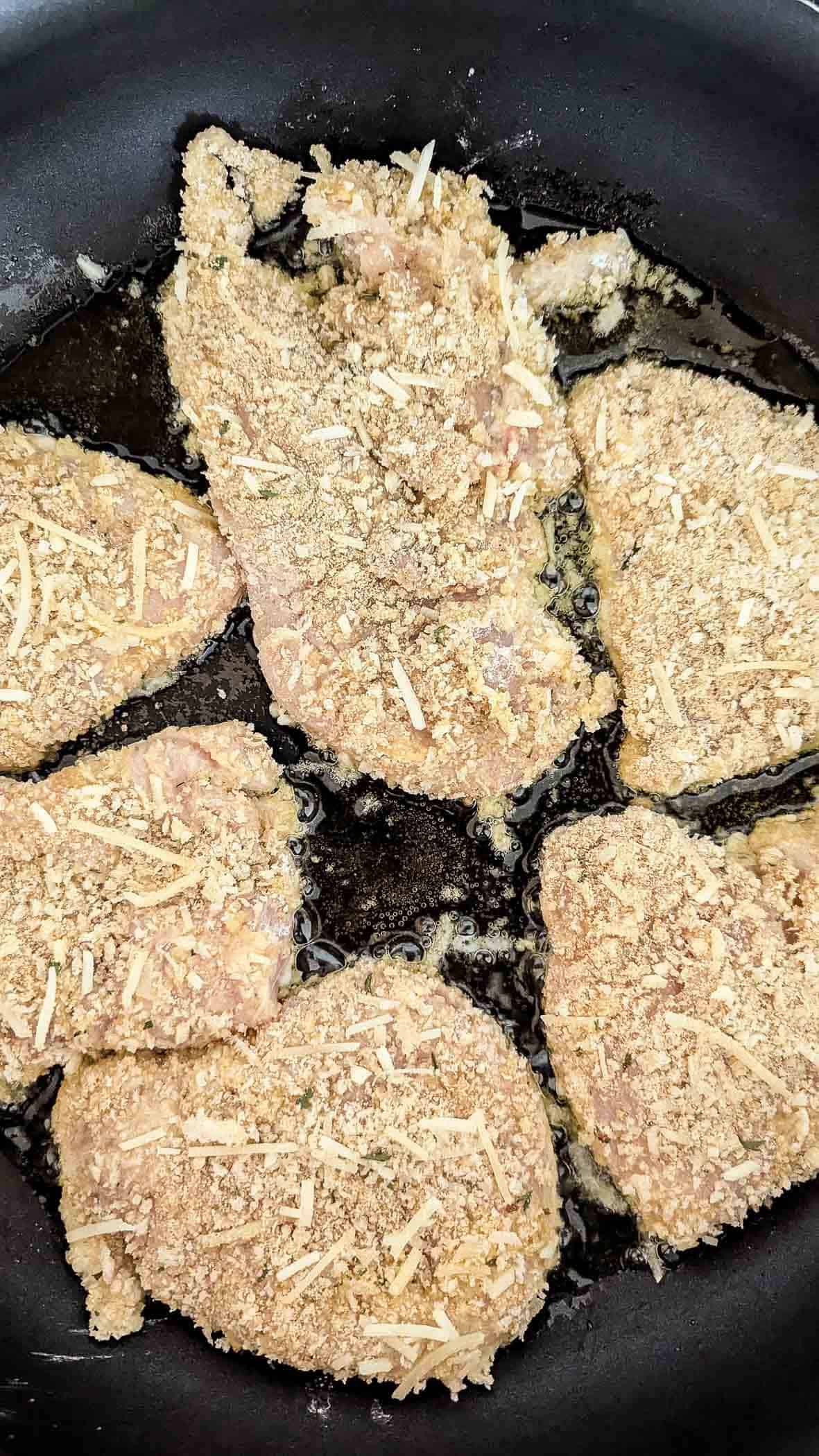 chicken fritta cooking in skillet.