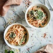 crockpot chicken spaghetti in bowls on countertop.