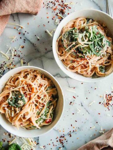 crockpot chicken spaghetti in bowls on countertop.