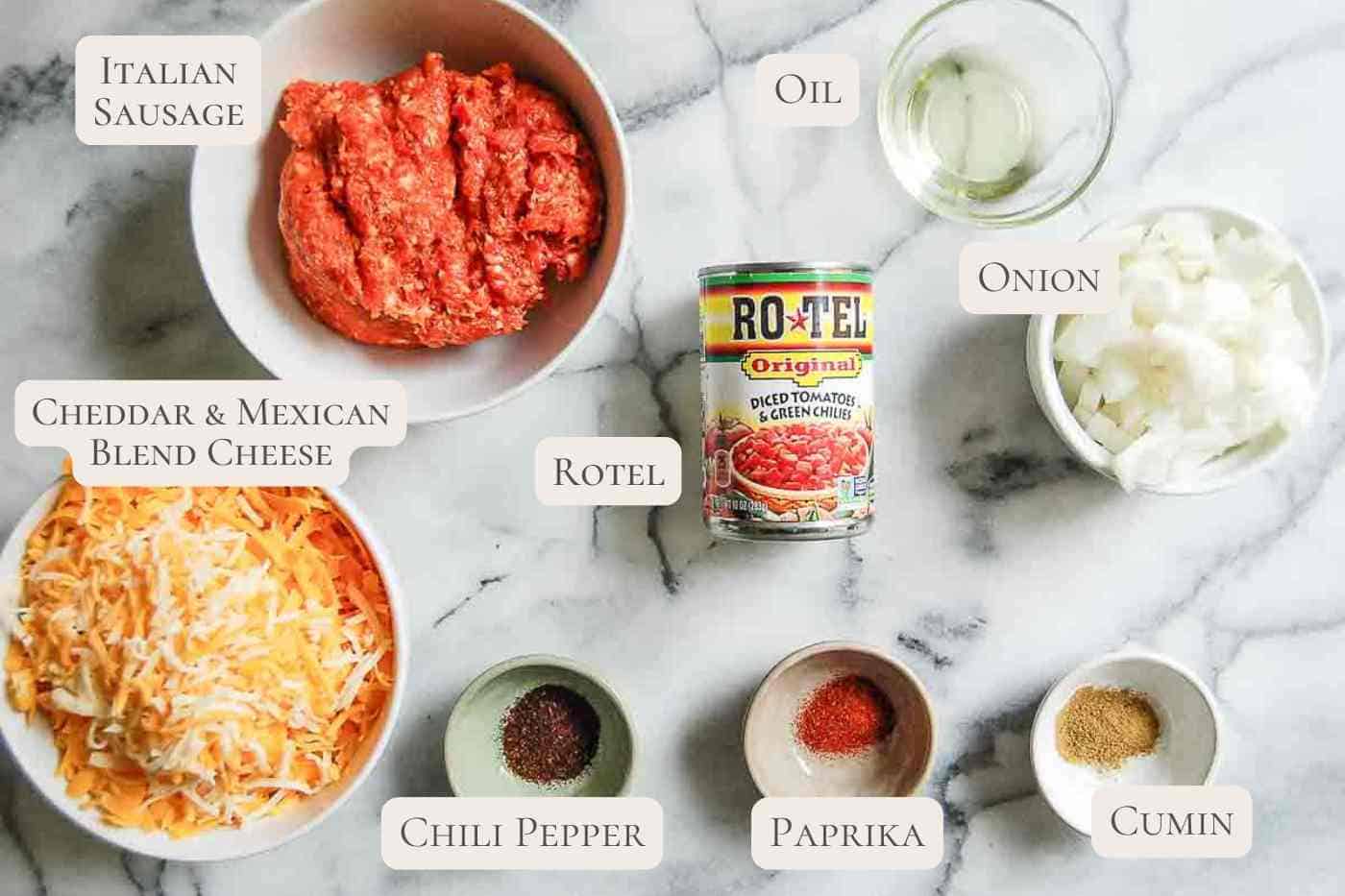 ingredients for rotel sausage dip on countertop, labeled.
