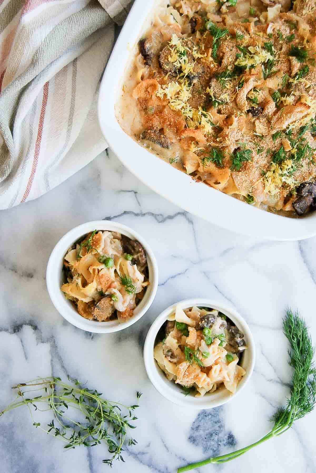 individual tuna helper casserole with larger casserole dish on the side.