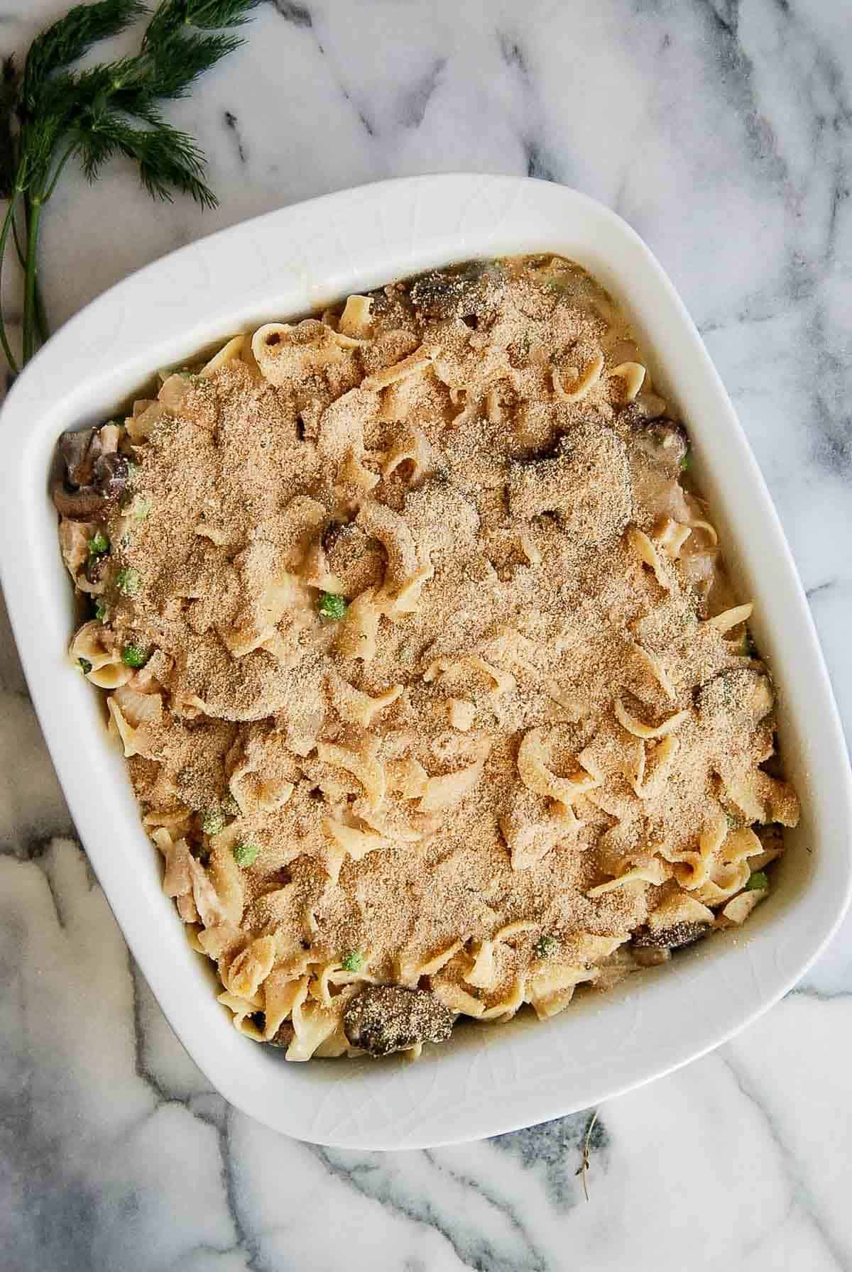 cheesy tuna noodle casserole with breadcrumb topping ready for baking.