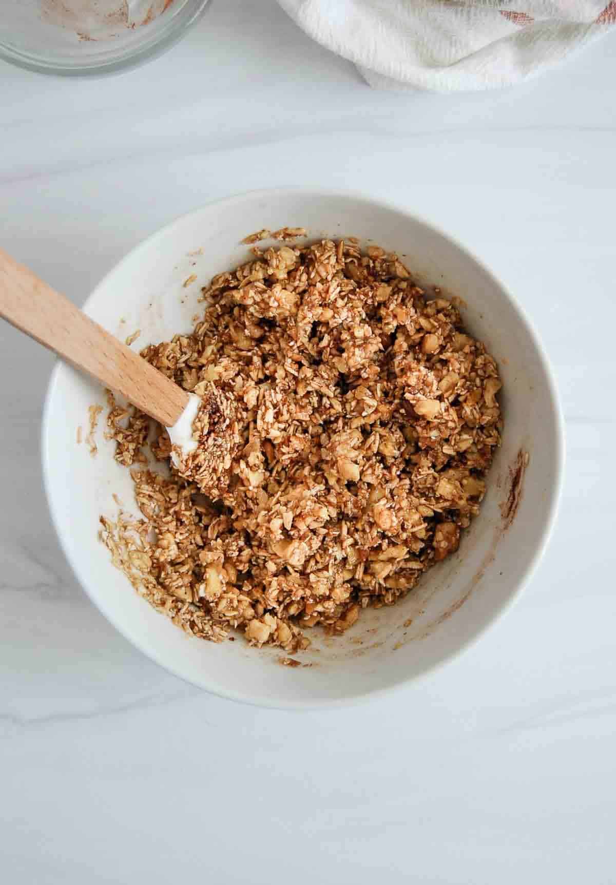 oats, walnuts, honey and cinnamon mixed in a bowl.