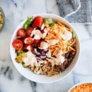loaded burger bowl with orzo, toppings and special sauce.
