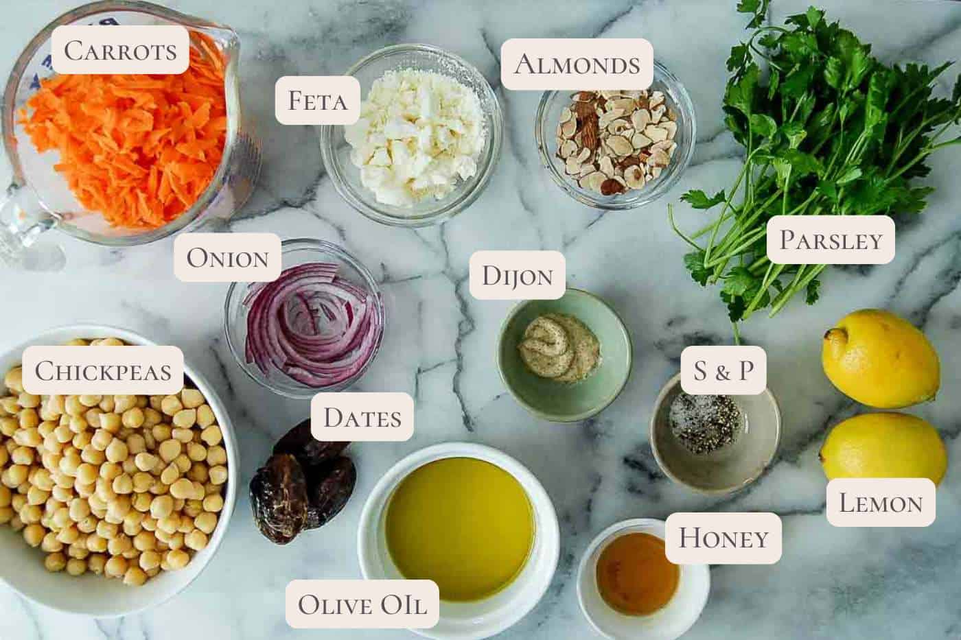 ingredients for carrot and chickpea salad on countertop, labeled.