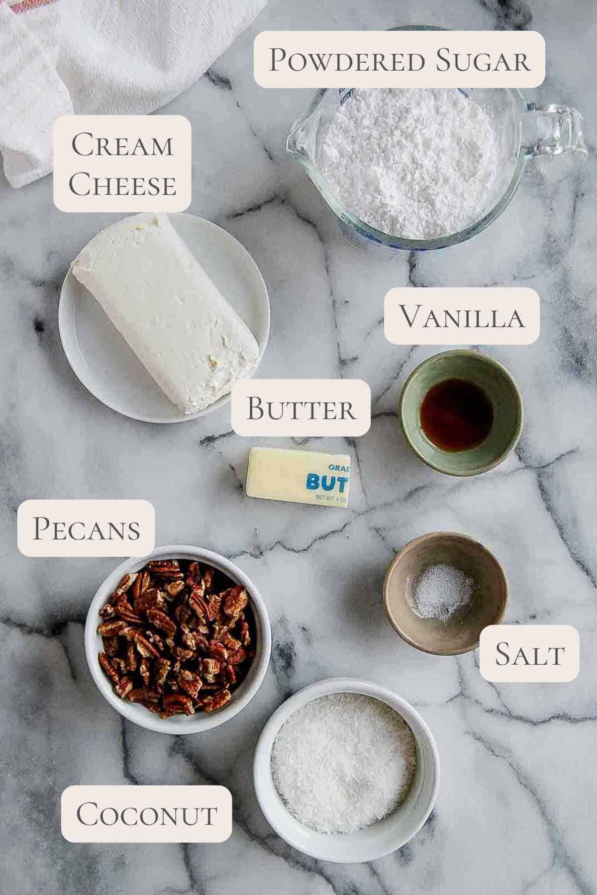 ingredients for coconut pecan cream cheese frosting on countertop, labeled.