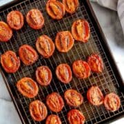 fire roasted tomatoes on baking sheet with wire rack.