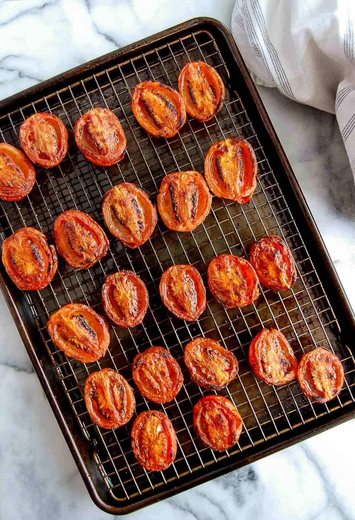 fire roasted tomatoes on baking sheet with wire rack.