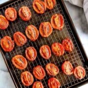 fire roasted tomatoes on baking sheet with wire rack.