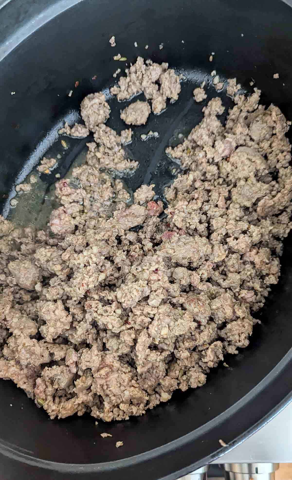 Italian sausage browning in pot.