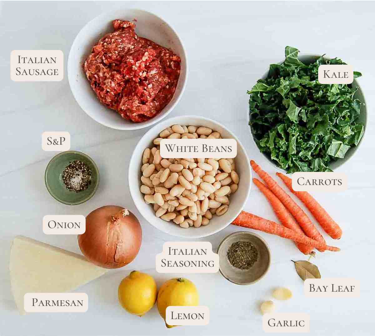 sausage kale and white bean soup ingredients on cutting board, labeled.
