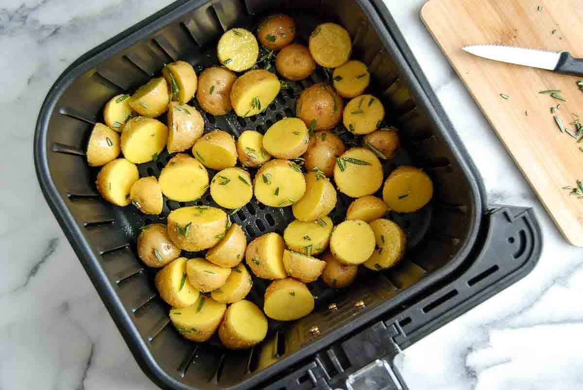 halved baby potatoes in air fryer with garlic and salt.