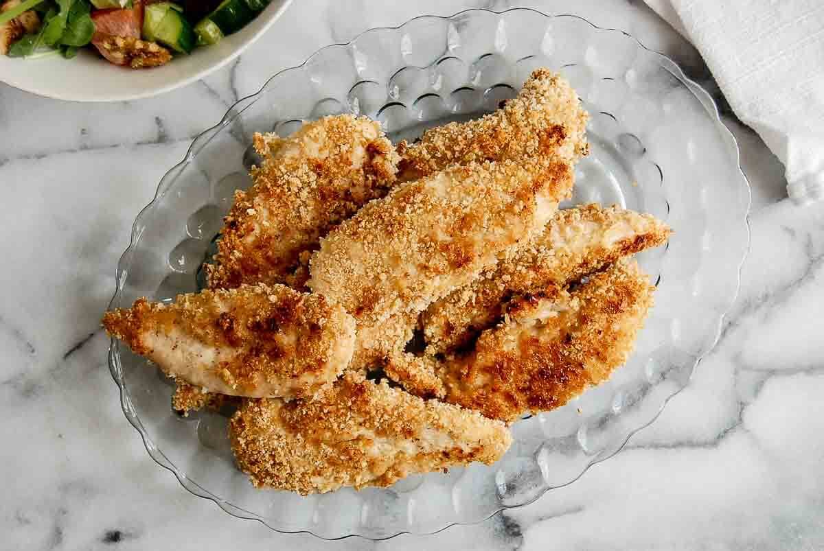 baked apple honey glazed chicken tenders on plate.