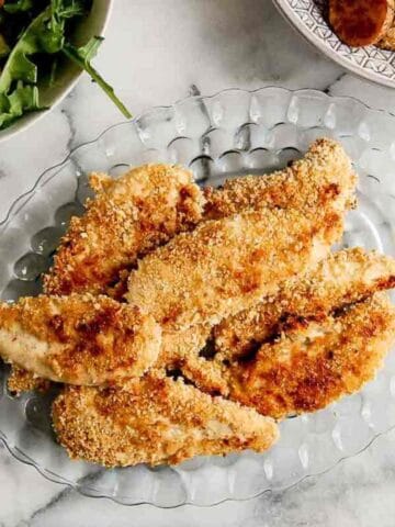 baked apple honey glazed chicken tenders on plate.