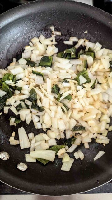 poblano peppers, onions and garlic sauteing in pan.