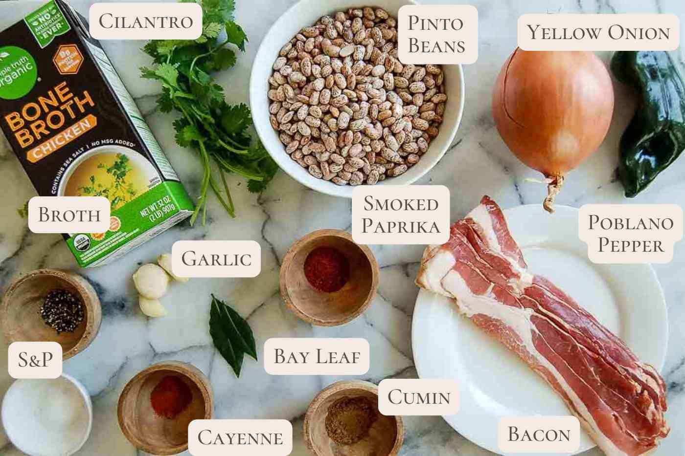 ingredients for crock pot pinto beans on countertop, labeled.