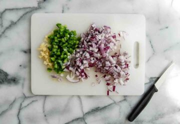 diced onion, jalapeno, and garlic on cutting board.