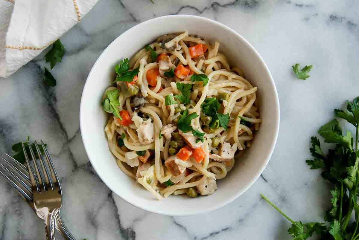 closeup of turkey tetrazzini in bowl with forks on the side.