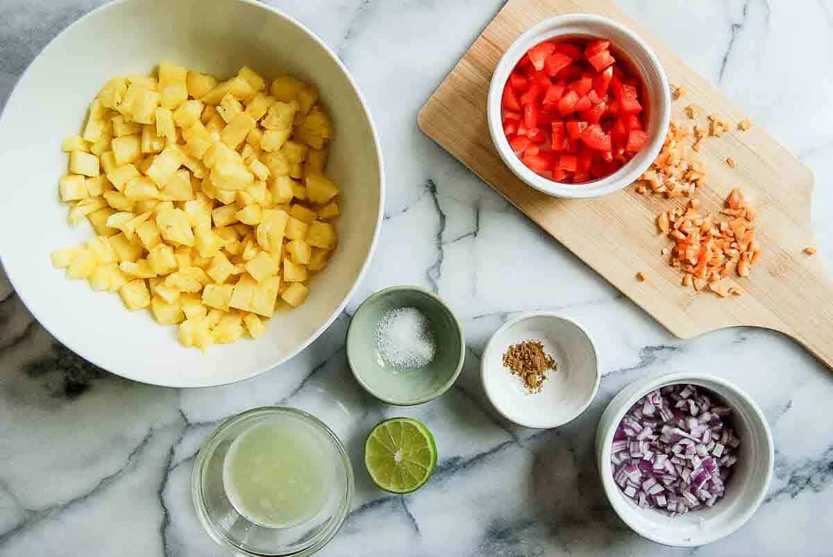 diced ingredients for pineapple salsa on countertop.