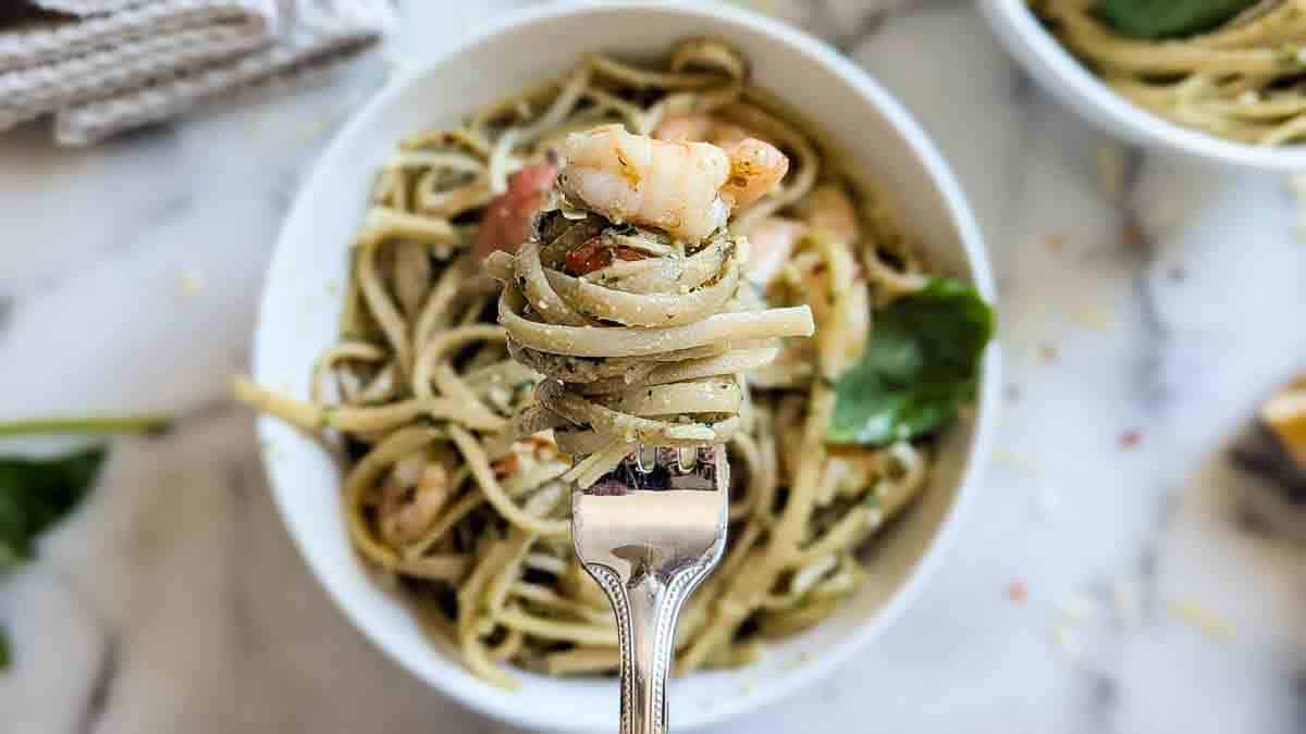 fork full of pesto shrimp pasta.