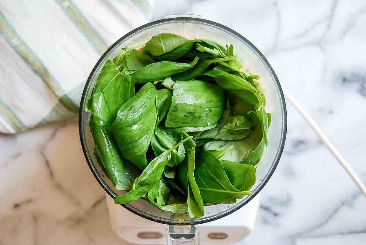 walnut mixture, cheese and basil leaves in food processor.