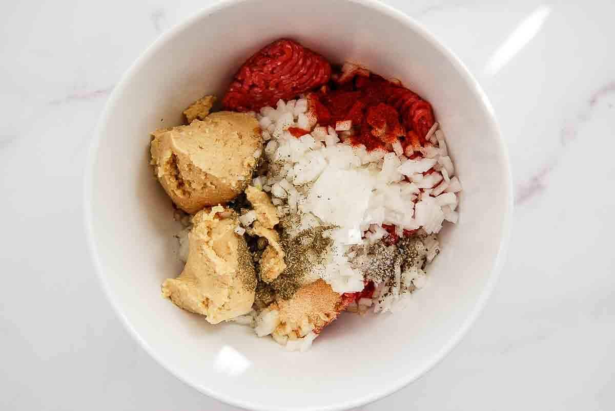 A white bowl containing meatloaf ingredients.