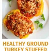 Two yellow bell peppers stuffed with ground turkey, topped with breadcrumbs, served on a white plate with parsley garnish. Text below reads: Healthy Ground Turkey Stuffed Peppers frontrangefed.com.