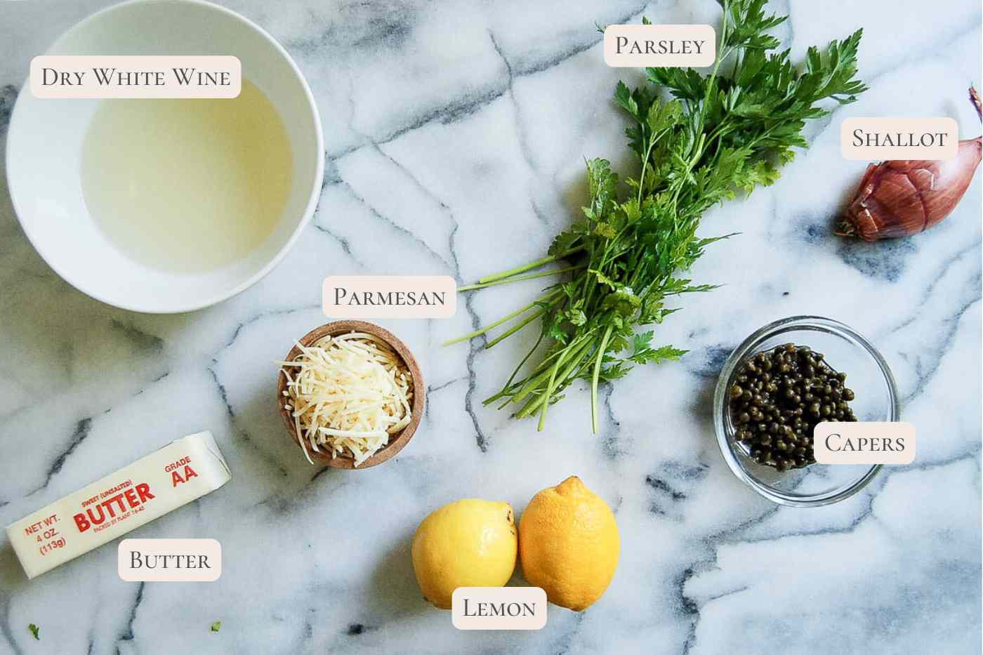 labeled ingredients for lemon caper sauce on countertop.