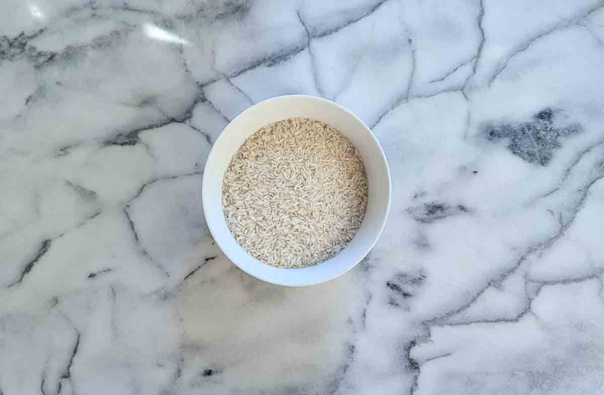 Rice in a bowl on a marble surface.