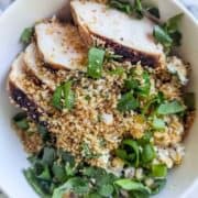 a street corn chicken rice bowl on a countertop.