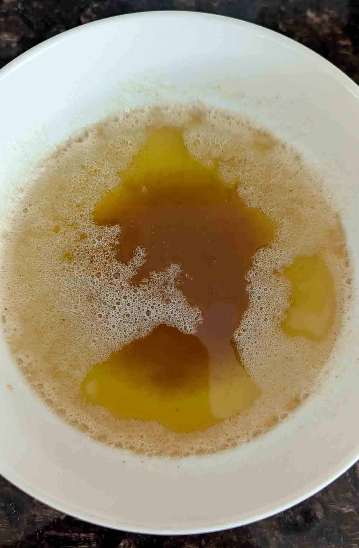 A white bowl filled with browned butter.